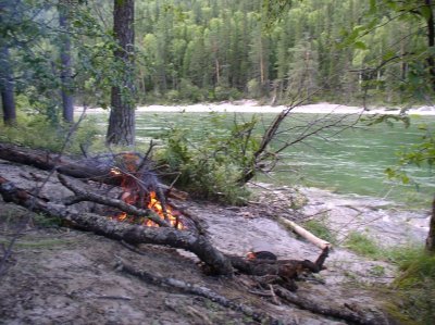 Fire warms-up and protects against mosqitos on the bank of Kytoy river
